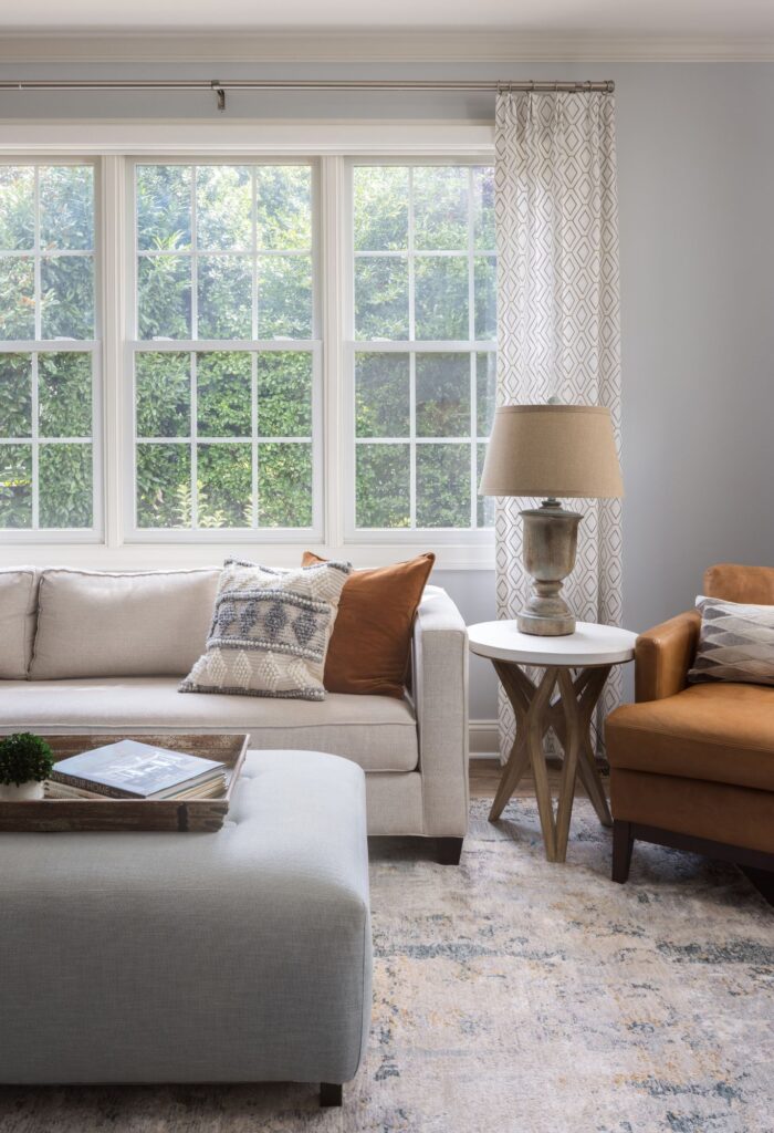 A family room with a couch and a coffee table. Contact Mesa, AZ family room interior decorator. 