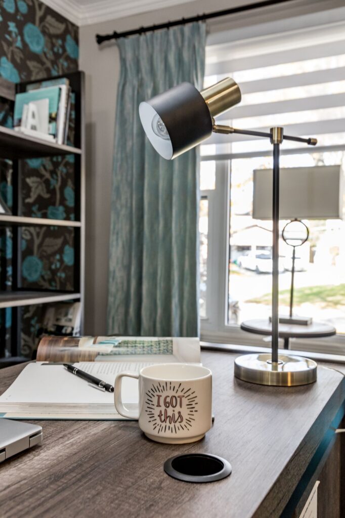 A desk in a home office with a lamp and a mug. the mug says "I got this." Contact Mesa, AZ home office interior decorator.